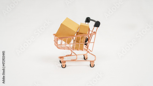 miniature trolley and stack of brown boxes isolated on white background