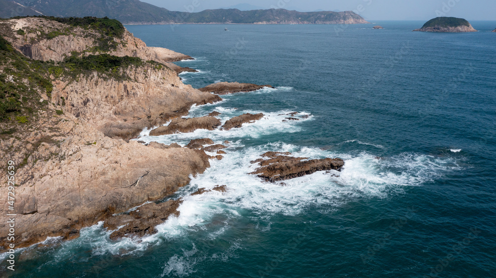 Aerial view of sea crashing waves White foaming waves on seashore rocks,Sai Kung,Hong Kong