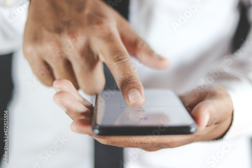 person using smartphone, close up of finger on screen mobile phone 
