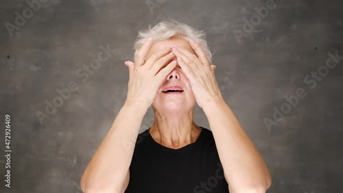 Happy smiling attractive middle aged woman touching face looking at camera. Advertising of skin care spa procedures concept. Closeup portrait