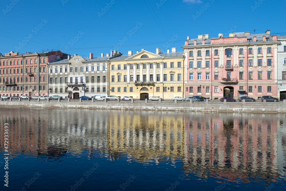 Facades of old houses on the embankment of the Fontanka river on a sunny March morning. Saint-Petersburg, Russia