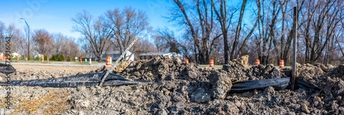 poorly maintained silt fence at a construction site with exposed dirt piled against the fabric photo