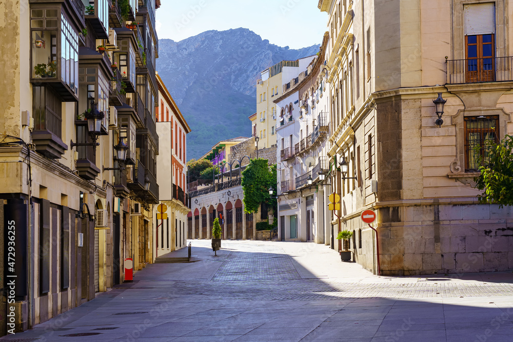 Pedestrian street in the ancient city of Jaen with a view of the high mountains that surround it in the background. Spain.