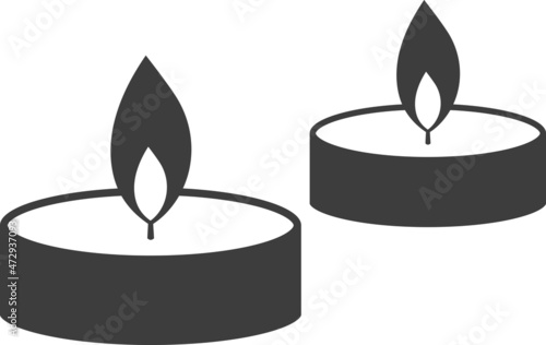 Christmas round wax candle in a flat candlestick.
