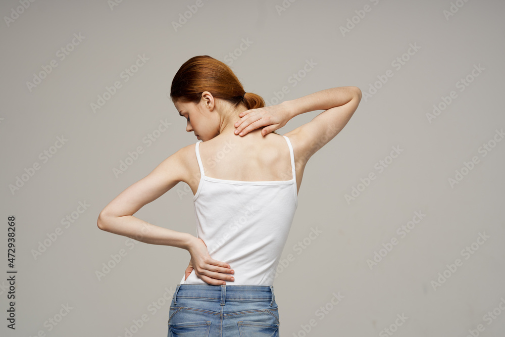 woman in white t-shirt back pain health problems osteoporosis studio treatment woman in white t-shirt back pain health problems osteoporosis studio treatment