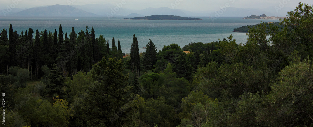 Panoramic Mediterranean landscape with island sea green cypress and olive trees. 