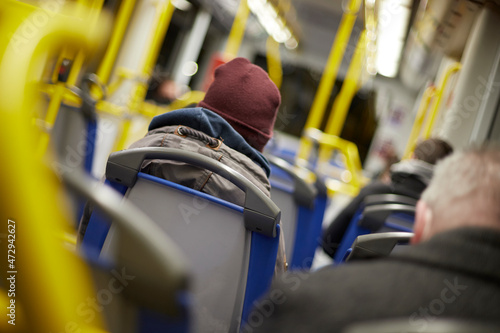 people sitting insite a waggon of a subway tram at winter time photo