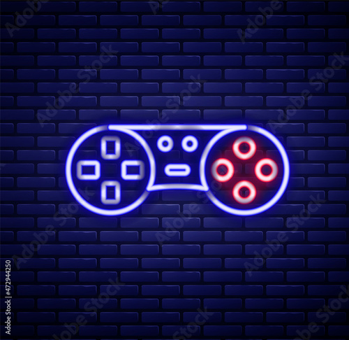 Glowing neon line Game controller or joystick for game console icon isolated on brick wall background. Colorful outline concept. Vector