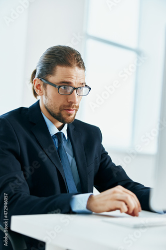 business man at his desk office typing on keyboard