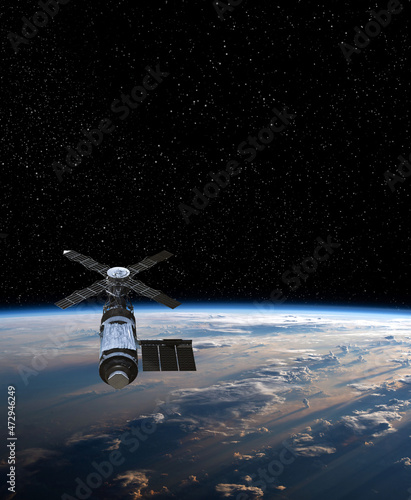 Fototapeta Naklejka Na Ścianę i Meble -  Cargo space craft and Earth planet. Dark background. Sci-fi wallpaper.Space Station Orbiting Earth.Space ship. Space art wallpaper.Solar Observatory.Elements of this image furnished by NASA.