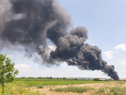 Big fire with smoke in rural countryside landscape.