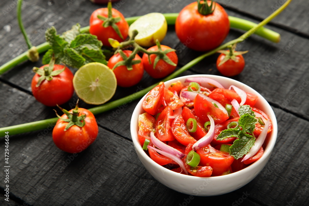Homemade delicious fresh organic tomato salad with exotic herbs. Homemade delicious fresh organic tomato salad with exotic herbs.