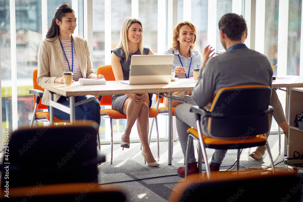 Young female commission talking with applicant during an interview for a new job position. Business, people, company