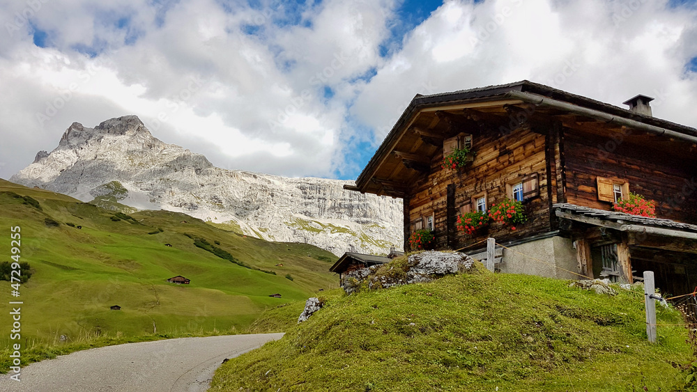 Typical wooden mountain hut in the Swiss Alps with Sulzfluh in the background. Typical wooden mountain hut in the Swiss Alps with Sulzfluh in the background.