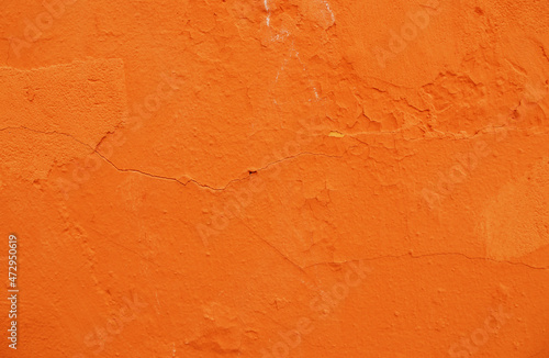 Abstract background of orange plaster on an old wall.