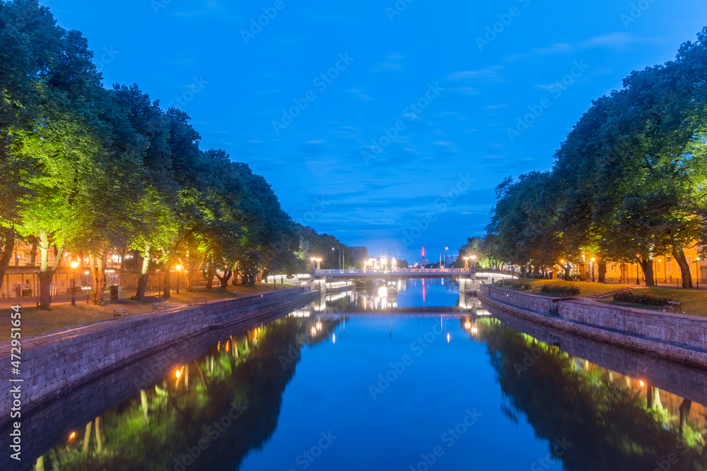 Turku early morning view on Aura River with illuminated embankments.