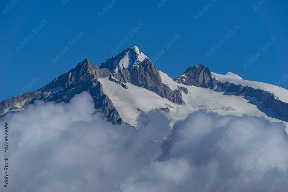 the glaciers and walls of the Swiss Alps in the canton of Valais, during a sunny summer day - July 2021.