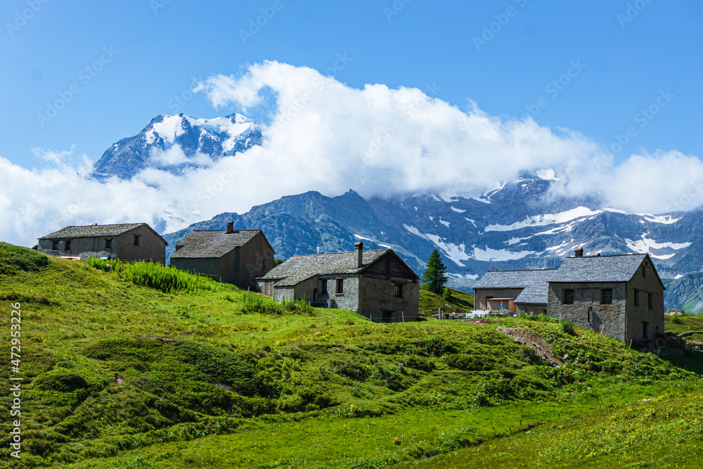 The mountain pastures and small villages among the meadows of the Simplon Pass (Switzerland), during a beautiful summer day - July 2021.