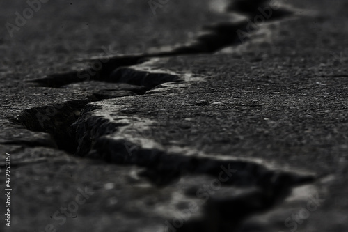 asphalt in cracks texture / abstract background cracks on asphalt road