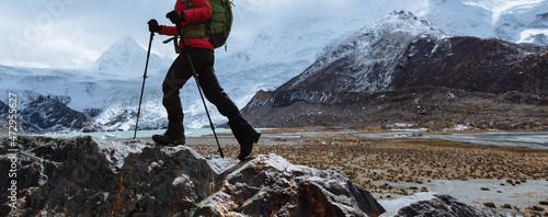 Canvas Print Woman backpacker hiking in winter high altitude mountains