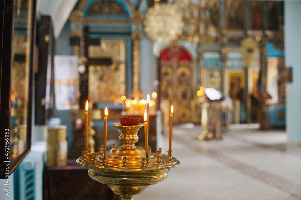 burning candles in church. Christianity religious background. Orthodox christian church interior.