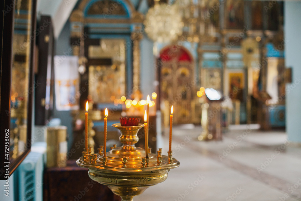 burning candles in church. Christianity religious background. Orthodox christian church interior. burning candles in church. Christianity religious background. Orthodox christian church interior.