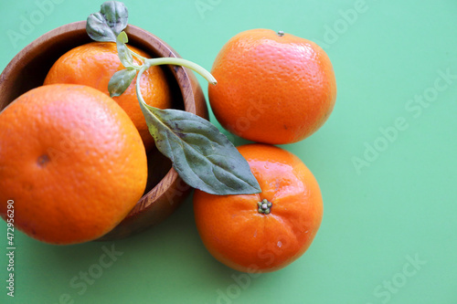 oranges and tangerines on a dark green background photo
