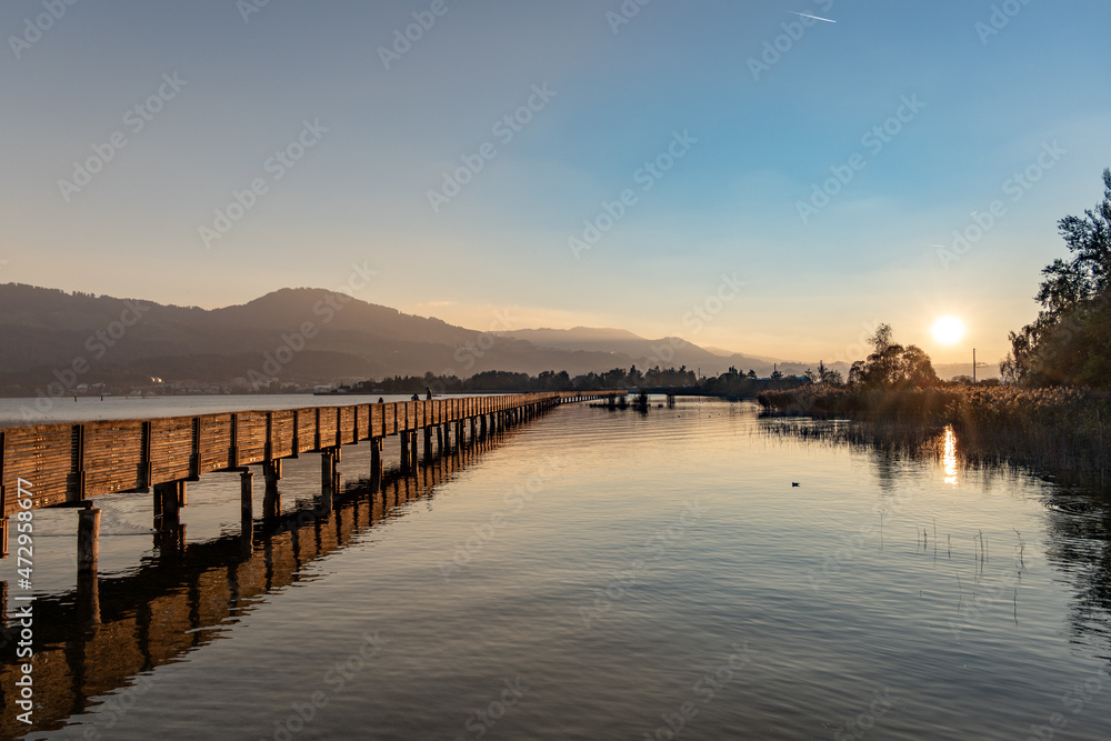 Autumn landscapes along the historical wooden brdige (holzteg) on the shores of the Zurich lake, Switzerland Autumn landscapes along the historical wooden brdige (holzteg) on the shores of the Zurich lake, Switzerland