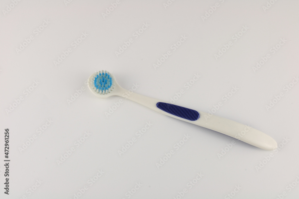 Tongue brush isolated on a plain background with copy space.  Oral hygiene concept