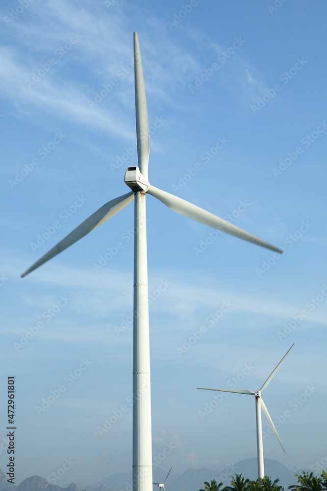 Wind mills on a blue-sky background. Wind mills on a blue-sky background.