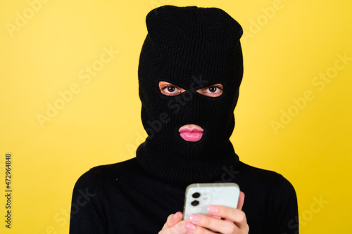 Canvastavla Young sexy beautiful woman with bright pink lips, balaclava on her head, holding