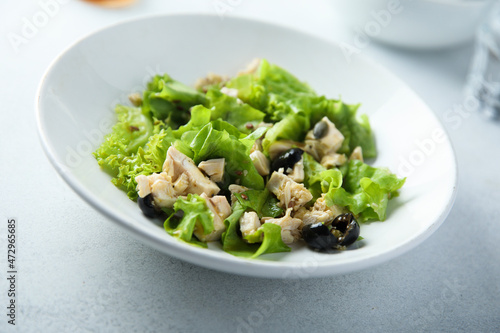 Healthy green salad with chicken and olives