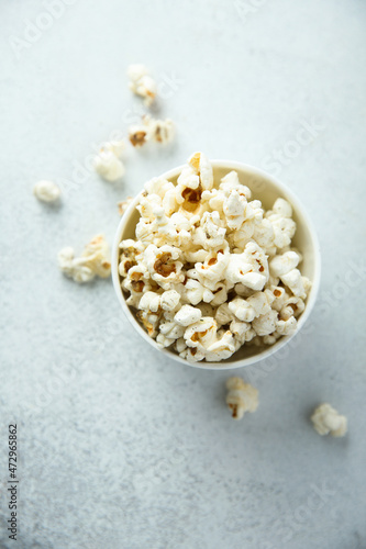 Homemade salted popcorn in a white bowl