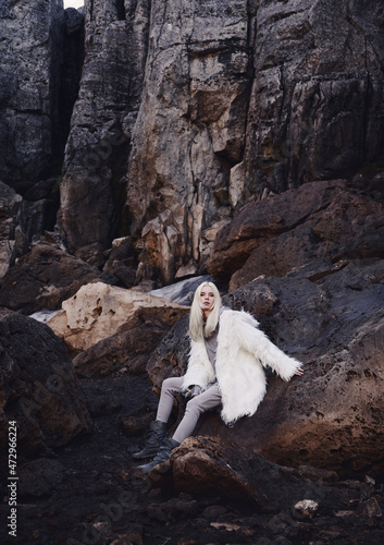 Fashion shooting in nature, a girl model in a fur coat made of artificial fur.