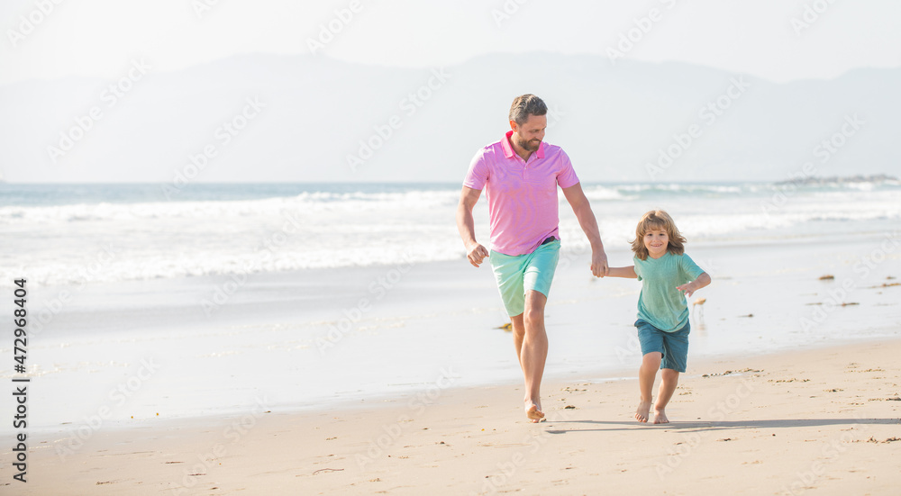 family of cheerful daddy man and child boy running on beach, activity family of cheerful daddy man and child boy running on beach, activity