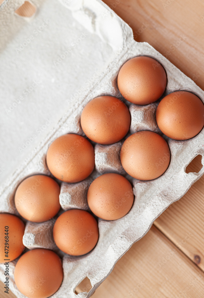 Few brown eggs among the cells of a large cardboard bag, chicken egg as a valuable nutritious product, a tray for carrying and storing fragile eggs. Not a full package of eggs, an important food item Few brown eggs among the cells of a large cardboard bag, chicken egg as a valuable nutritious product, a tray for carrying and storing fragile eggs. Not a full package of eggs, an important food item