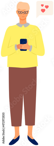 Young man uses smartphone. Guy holding gadget. Pastime in social networks. Internet addiction. Smiling boy sends messages via smartphone. Happy person uses mobile phone for texting and communication