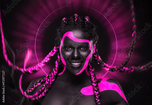 Abstract art with woman with face art. Neon colors. Pink and black body paint. Young girl with colorful bodypaint. An amazing afro american model with makeup. photo