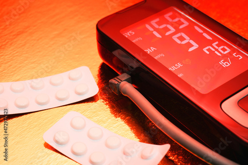 tonometer shows high blood pressure, stroke, heart attack. photographed with red flash