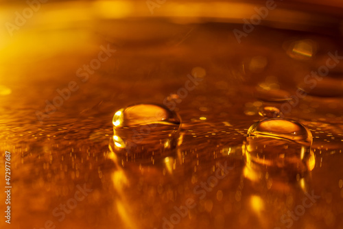 Oil drops and bubbles on a metal gear engine surface. Closeup photo. Soft focus.