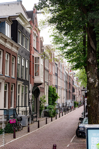 street view with buildings, greenery, sky and canals