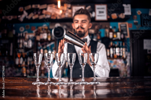 Charming bartender adds ingredients to a cocktail in the nightclub Stock  Photo | Adobe Stock