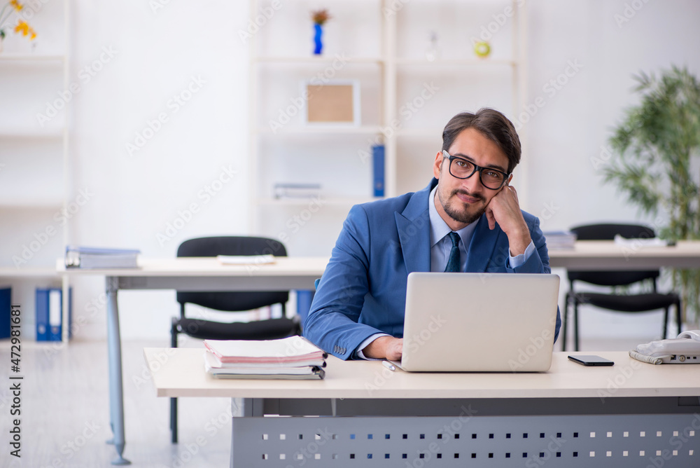 Young male employee working in the office Young male employee working in the office