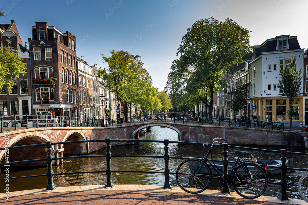 Street view with buildings and during day and canal in Amsterdam, Netherlands