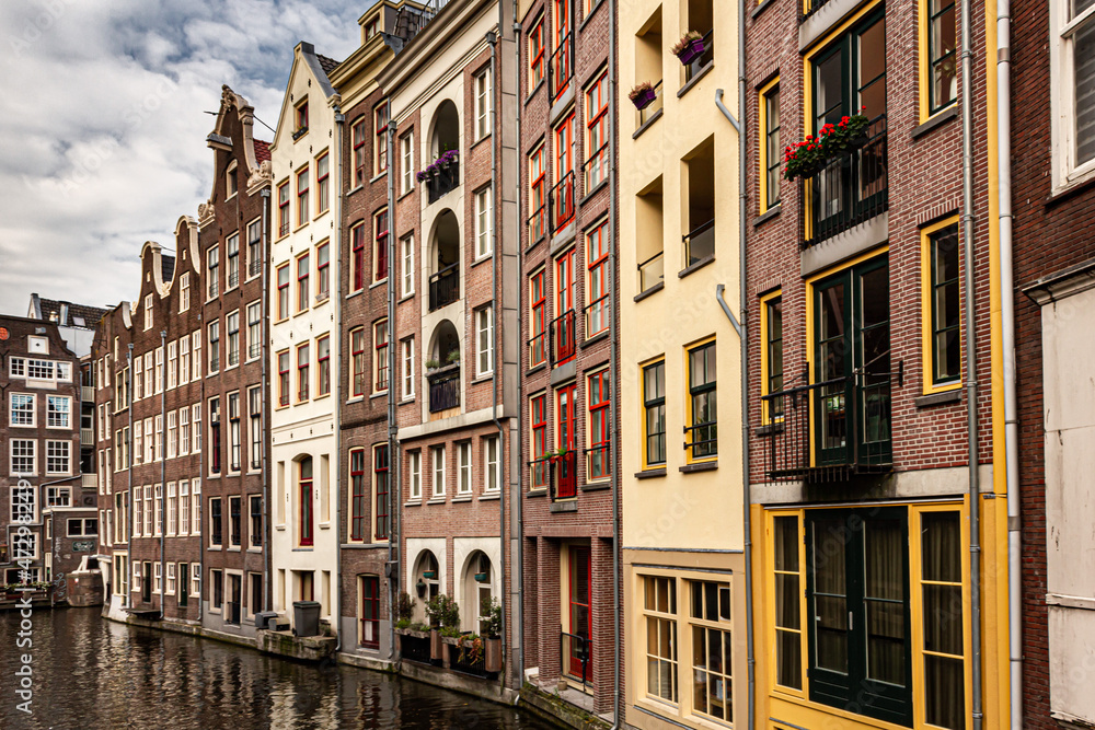 Street view with buildings and during day and canal in Amsterdam, Netherlands