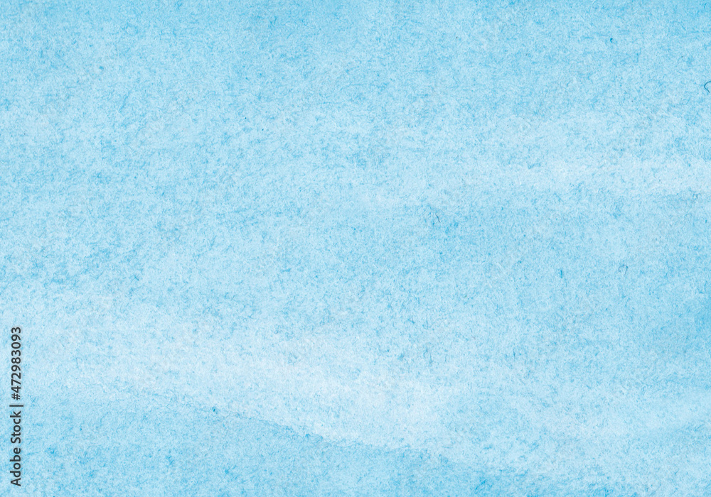 Obraz premium The texture of the paper is covered with blue watercolor