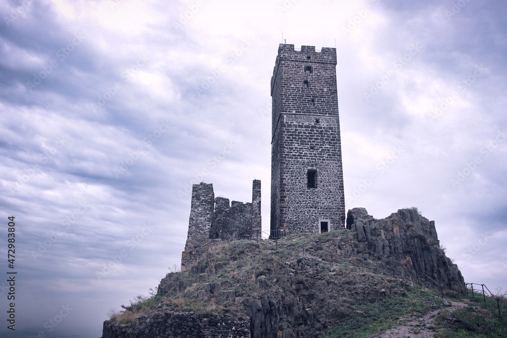 A dramatic view to the historical tower on the hill at castle Hazmburk, Czech republic