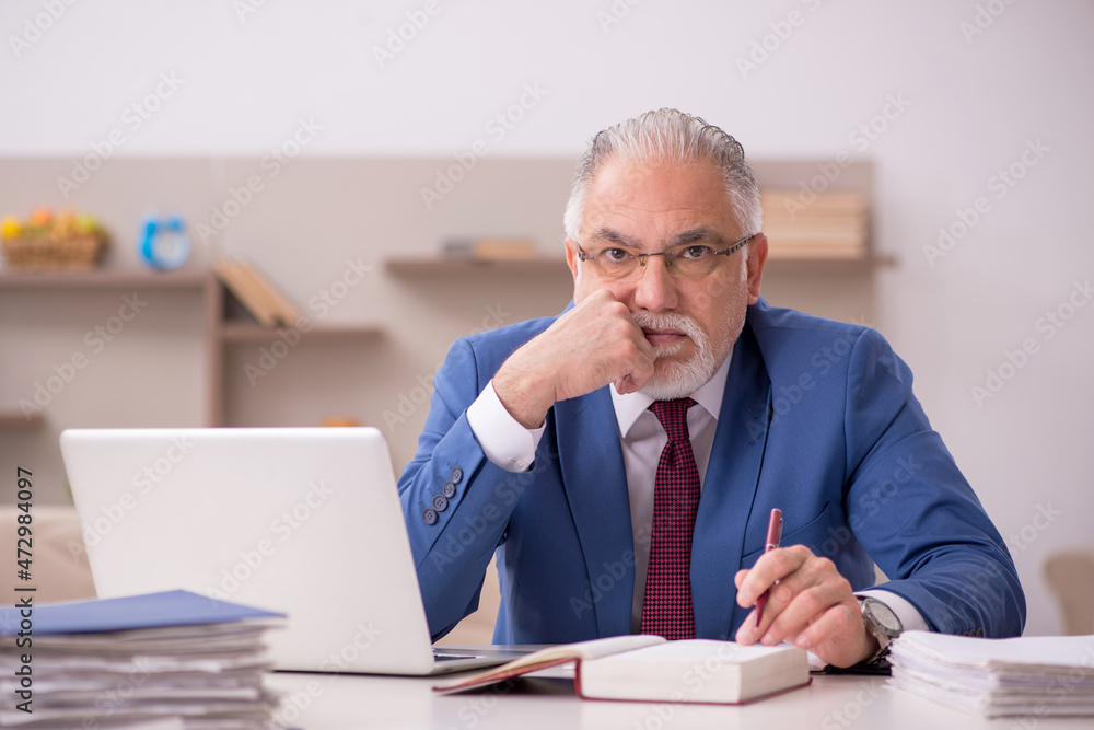 Fototapeta premium Old male employee working from home during pandemic