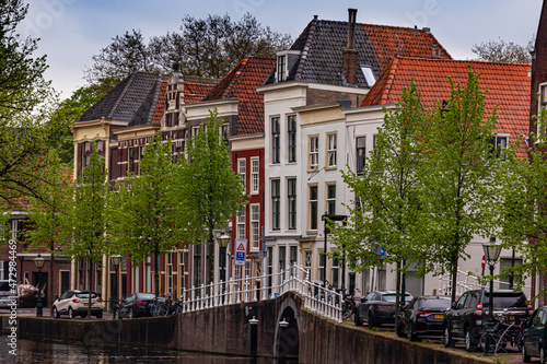 Beautiful and quaint street view with old buildings and greenery in spring in Leiden, Netherlands