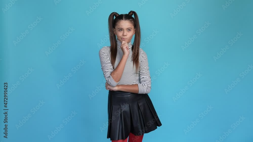 Minded kid touch chin decide thoughts isolated blue color background Minded kid touch chin decide thoughts isolated blue color background